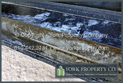 Cleaning concrete residue off of bronze anodized aluminum window frames.