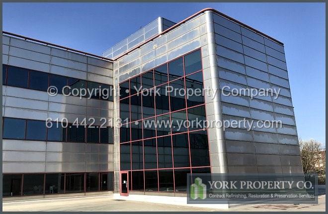 Cleaning dirty exterior metal stainless steel clad panels.