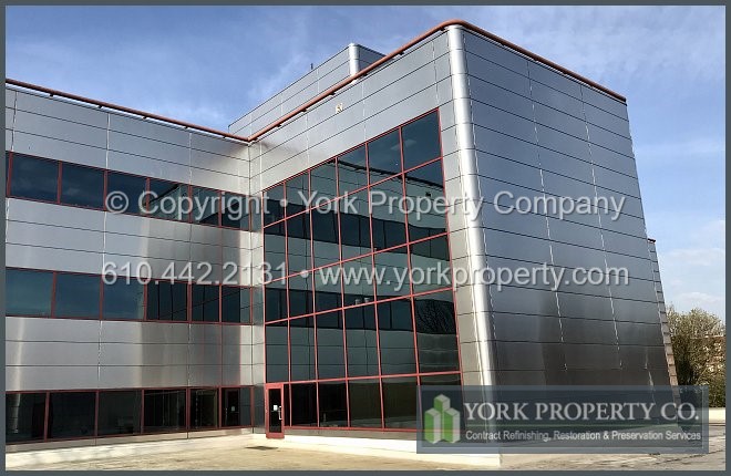 Repairing damaged stainless steel panels in an exterior building facade.