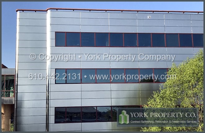 Oxidized stainless steel building facade restoration company.