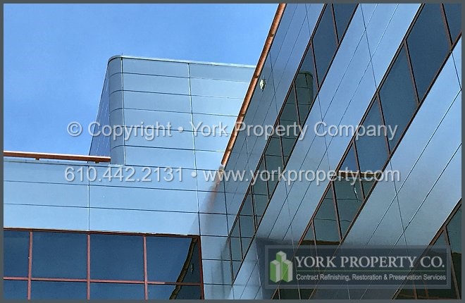 Contractor that cleans old stainless steel building facade panels.