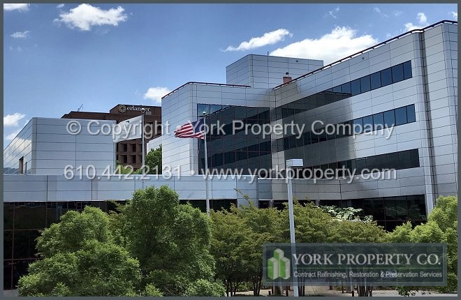 Company that washes dirty stainless steel building facade panels.